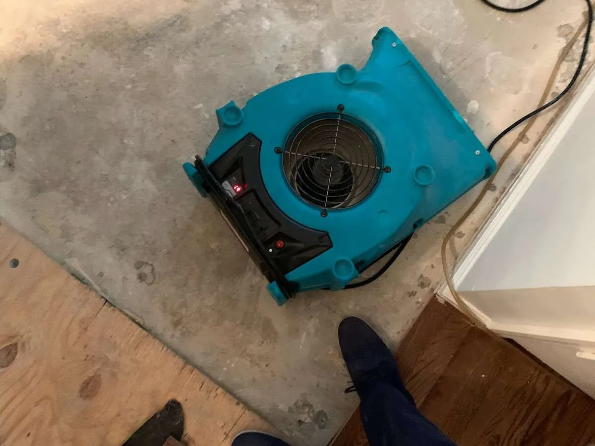 Air mover drying subfloor during Commercial Water Damage Restoration in Ripon